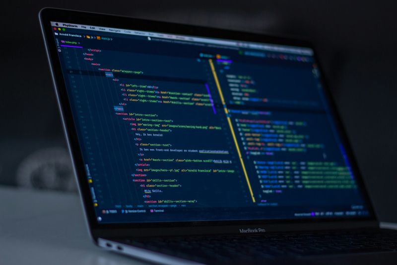 MacBook with code, dark theme