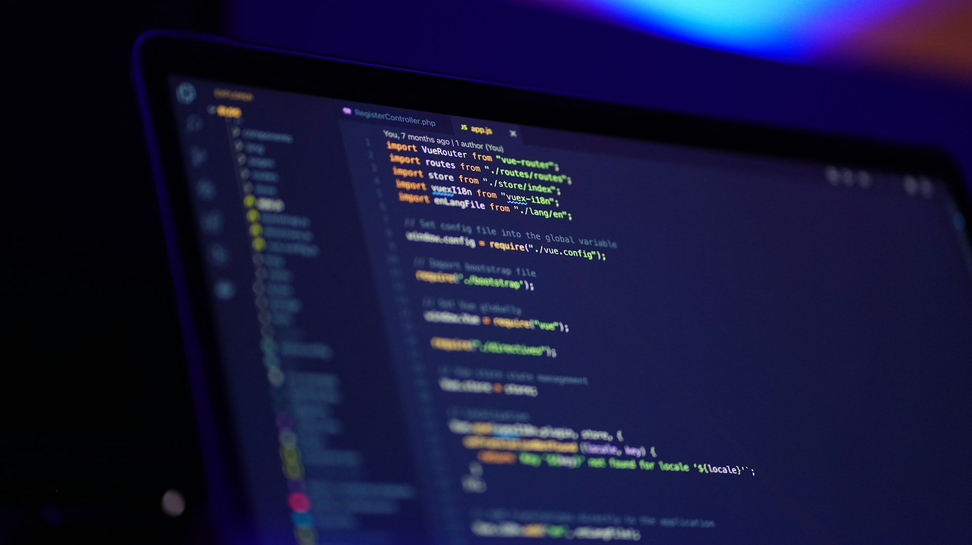 Code editor close-up on a dark screen, violet ambient light
